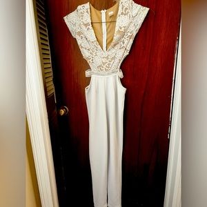Off white jump suit with cut out sides.